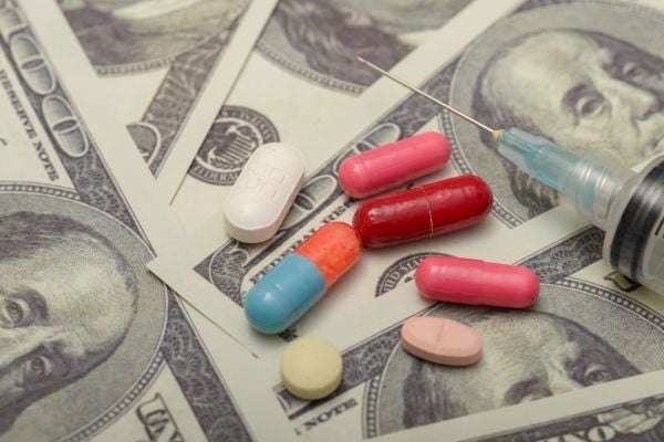 Colorful pills on $100 bills