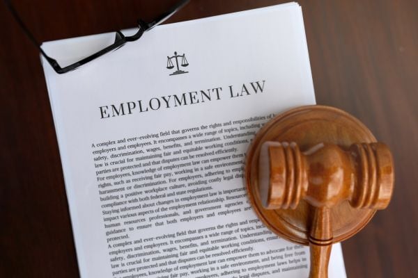 Employe labor laws document with wooden gavel on top