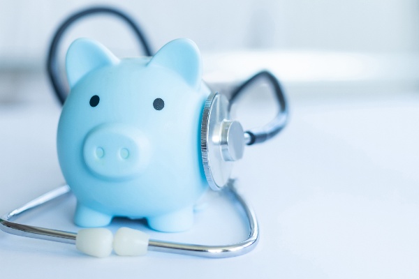 blue piggy bank with a stethoscope draped over it, representing health savings accounts