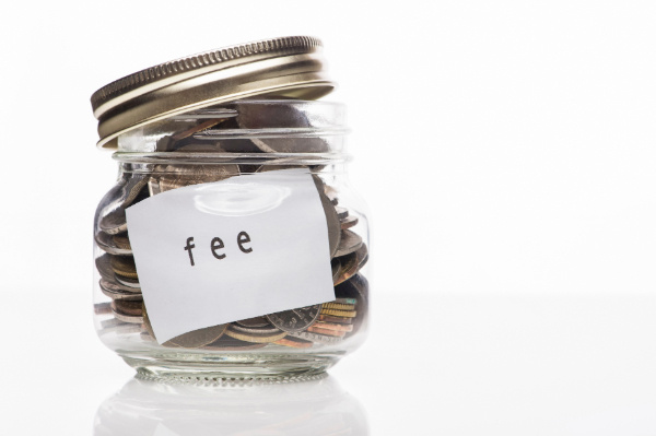 jar filled with coins with a fee label on the front