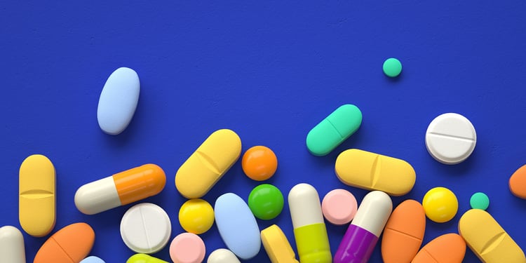 Prescription pills on a blue table