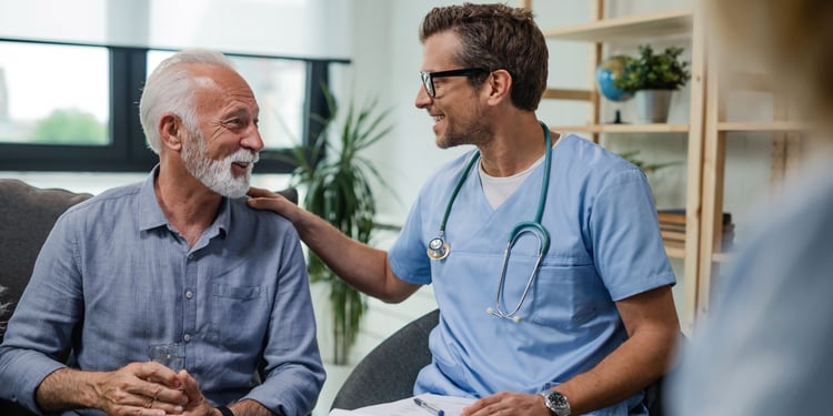 Smiling doctor talking to a happy patient