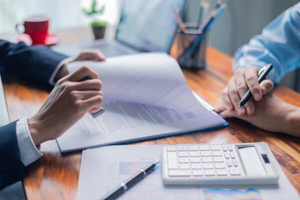 People reviewing business risks