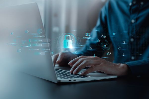 Person at laptop with lock icon overlay, representing website access